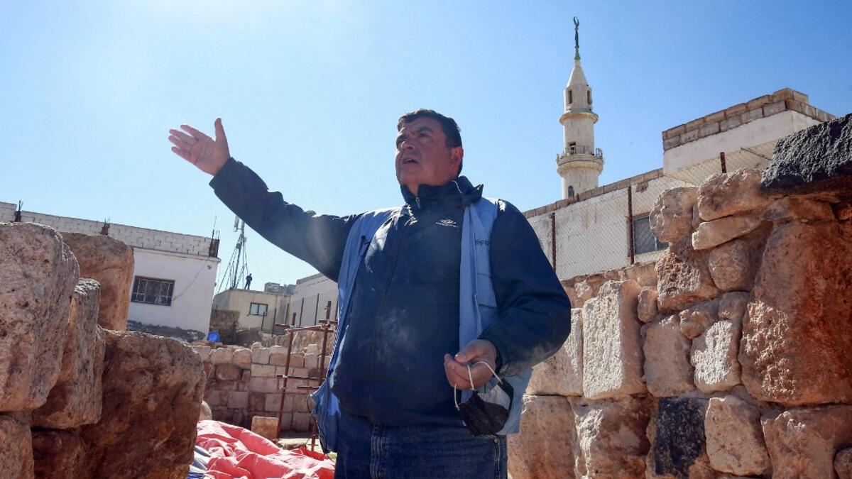 Franco Sciorilli, an Italian expert, speaks to AFP as he supervises workers employed by a pilot project run by the UN cultural agency UNESCO, to restore an ancient church complex, in the small town of Rihab, some 70 kilometres north of the Jordanian capital Amman, on February 9, 2021. In the ruins of the ancient Byzantine church in Jordan, local townspeople and Syrian refugees work side by side on a project that unites preserving cultural heritage and fighting poverty.  Khalil MAZRAAWI / afp