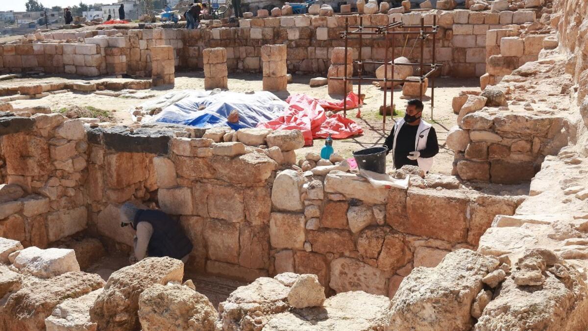 Workers employed by a pilot project run by the UN cultural agency UNESCO, restore a stone wall at an ancient church complex, in the small town of Rihab, some 70 kilometres north of the Jordanian capital Amman, on February 9, 2021. In the ruins of the ancient Byzantine church in Jordan, local townspeople and Syrian refugees work side by side on a project that unites preserving cultural heritage and fighting poverty.  Khalil MAZRAAWI / afp