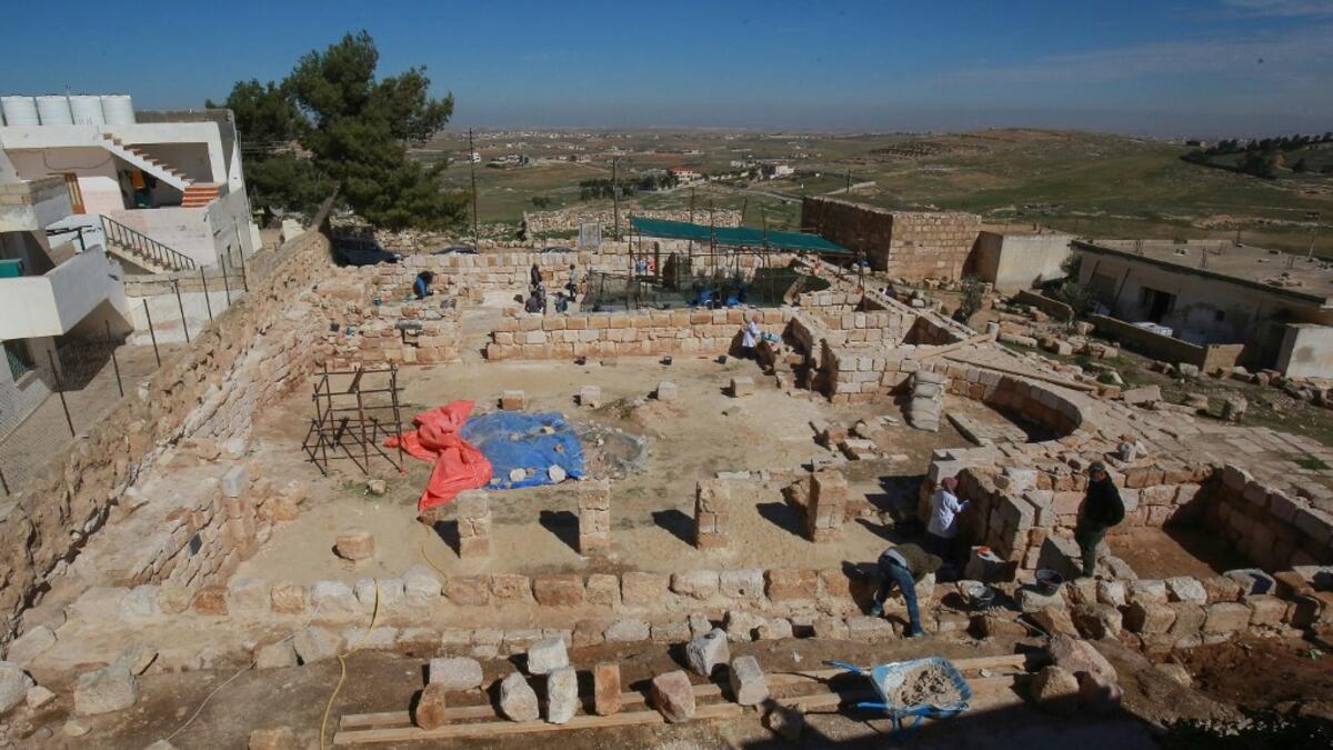 Workers employed by a pilot project run by the UN cultural agency UNESCO, restore a stone wall at an ancient church complex, in the small town of Rihab, some 70 kilometres north of the Jordanian capital Amman, on February 9, 2021. In the ruins of the ancient Byzantine church in Jordan, local townspeople and Syrian refugees work side by side on a project that unites preserving cultural heritage and fighting poverty.  Khalil MAZRAAWI / afp