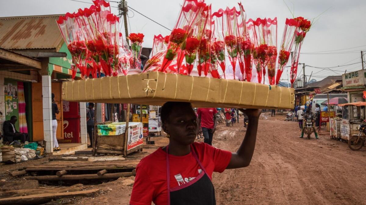 A street vendor sells artificial red flowers for the Valentine's day, in Kampala, on February 13, 2021. Badru KATUMBA / AFP