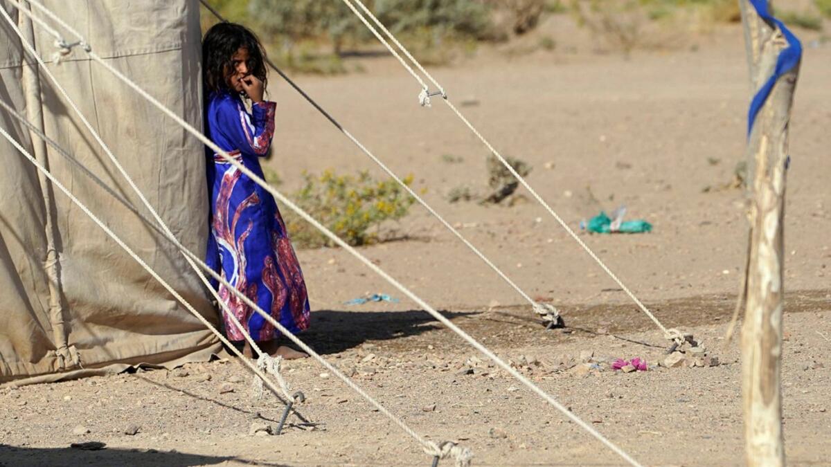 A Yemeni girl stands at a camp for internally displaced people on the outskirts of the northern city of Marib, on February 18, 2021 in the Saudi-backed Yemeni government's last northern bastion. Until early last year, life in Marib city was relatively peaceful despite the Yemen's civil war that erupted in 2014. The United Nations warned last week of a potential humanitarian disaster if the fight for Marib continues, saying it has put "millions of civilians at risk". More than 3.3 million have been displaced