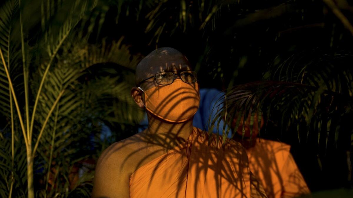 Buddhist monks prepare to take their place ahead of prayers during Makha Bucha celebrations at Wat Dhammakaya, north of Bangkok on February 26, 2021. Jack TAYLOR / AFP