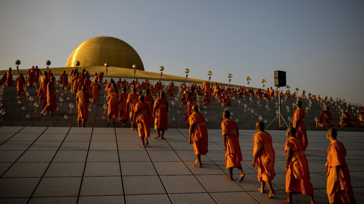 Buddhist monks prepare to take their place ahead of prayers during Makha Bucha celebrations at Wat Dhammakaya, north of Bangkok on February 26, 2021. Jack TAYLOR / AFP
