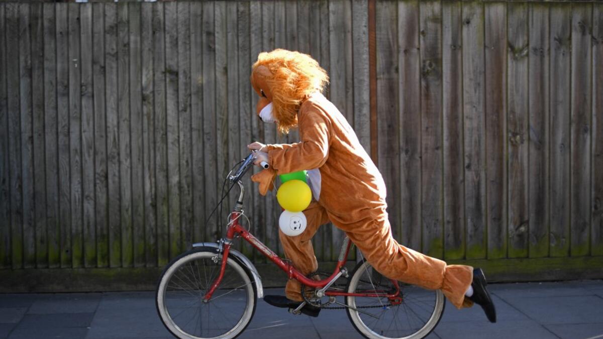 A reveller dressed in costume in celebration of the Jewish holiday of Purim, cycles along a street in the Orthodox Jewish neighborhood of Stamford Hill in north London on February 26, 2021. The carnival-like Purim holiday is celebrated with parades and costume parties to commemorate the deliverance of the Jewish people from a plot to exterminate them in the ancient Persian Empire 2,500 years ago, as recorded in the Biblical Book of Esther. DANIEL LEAL-OLIVAS / AFP