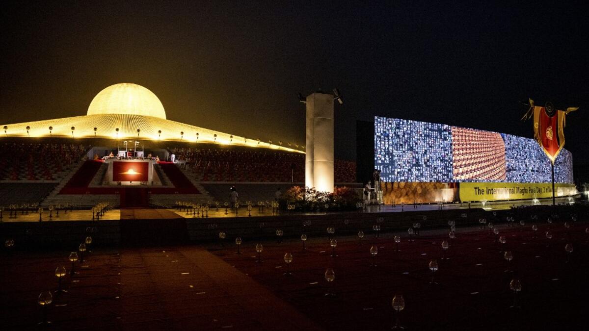 A screen of attendees, appearing via video conferencing, due to the Covid-19 coronavirus pandemic, is displayed during Makha Bucha celebrations at Wat Dhammakaya, north of Bangkok on February 26, 2021. Jack TAYLOR / AFP