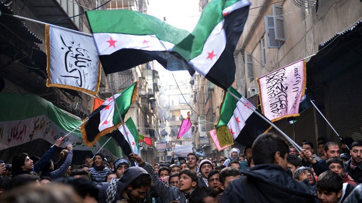 Syrian anti-regime protesters wave pre-Baath Syrian flags