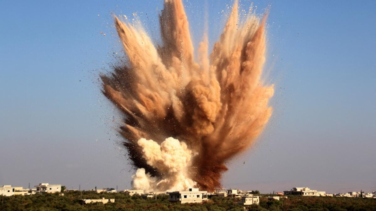 smoke billows above buildings following a reported attack on a tunnel