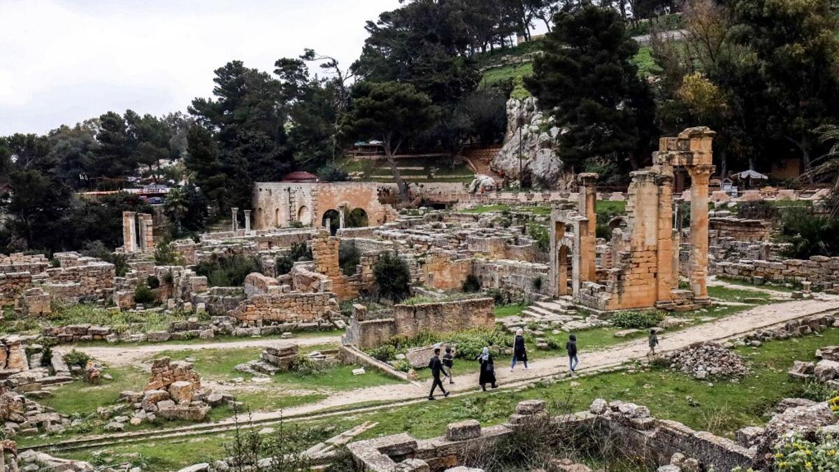 People walk through the remains of the Sanctuary of Apollo in the ruins of Libya's eastern ancient city of Cyrene