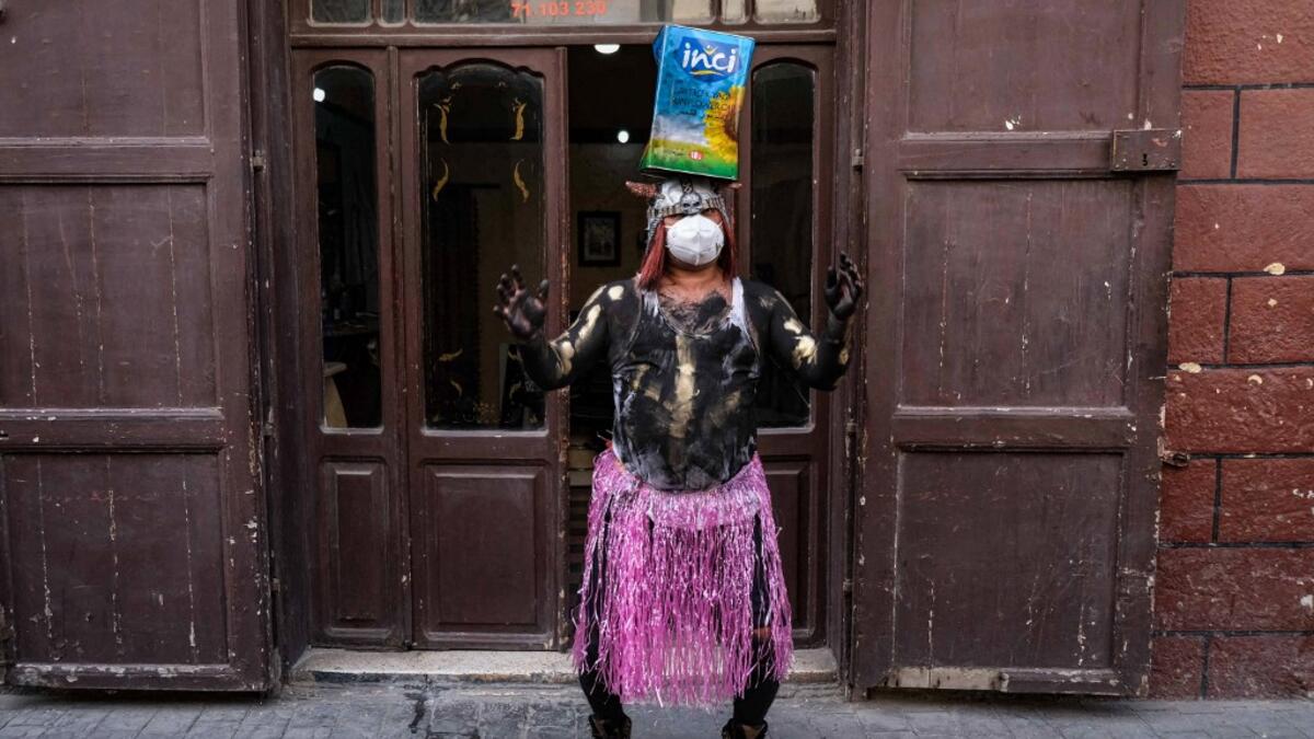 A carnival participant dressed in costume and wearing body paint