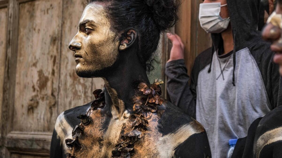 A carnival participant dressed in costume and wearing body paint