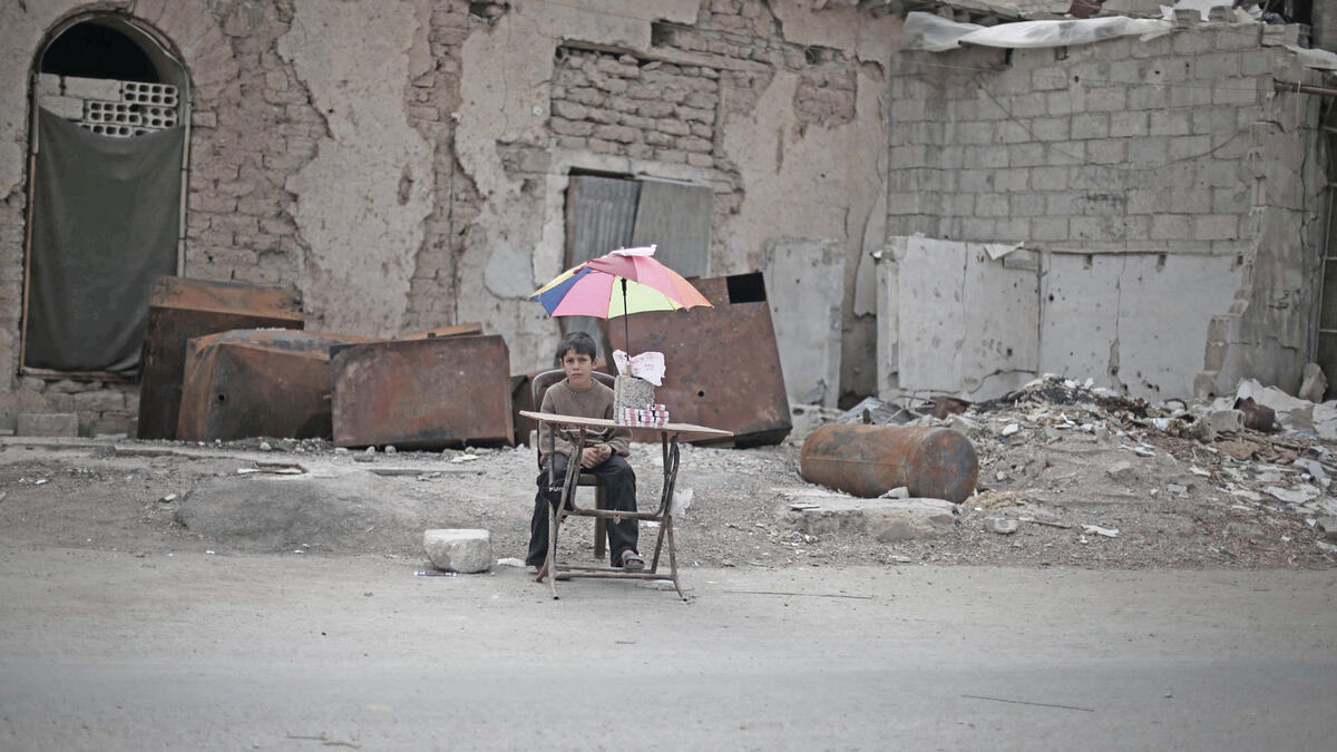 On 29 October 2015 in East Ghouta, rural Damascus, an internally displaced boy sits with items he will sell.