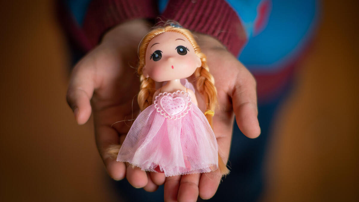 Yara, 10 years, holds a doll in Za’atari Refugee Camp.