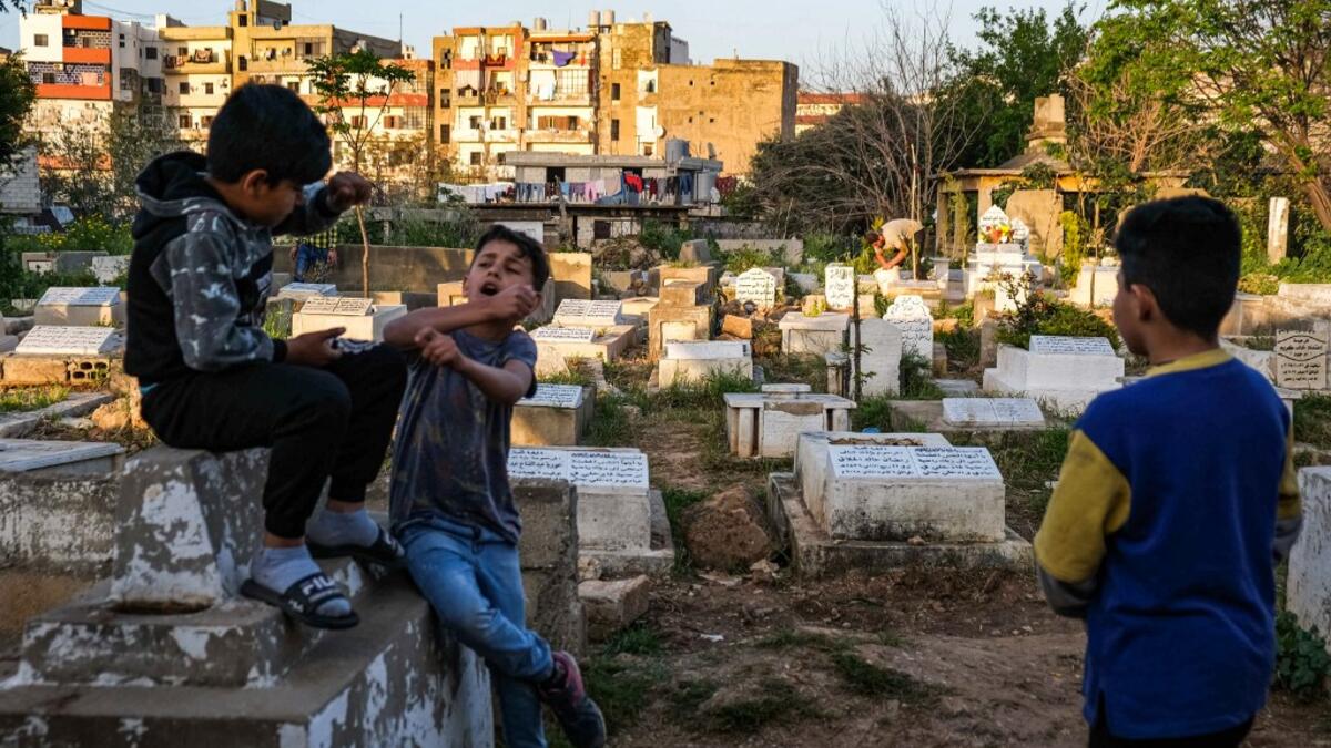 hildren argue by a grave in the Ghoraba (Strangers) cemetery, named after the neighbourhood where it is situated in Lebanon's northern port city of Tripoli