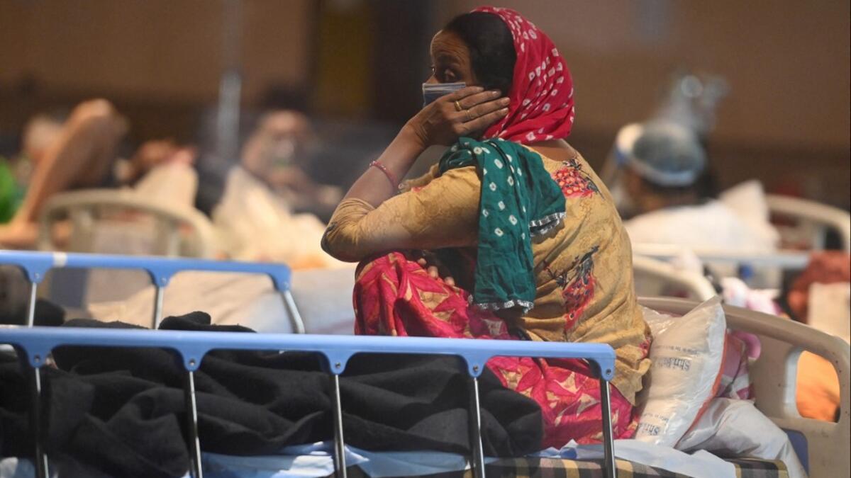 A patient rests inside a banquet hall temporarily converted into a Covid-19 coronavirus ward in New Delhi