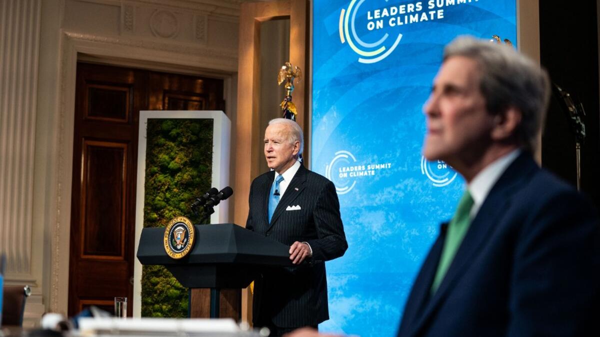 U.S. President Joe Biden delivers remarks as Special Presidential Envoy for Climate and former Secretary of State John Kerry listens during day 2 of the virtual Leaders Summit on Climate at the East Room of the White House April 23, 2021 in Washington, DC. Biden pledged to cut greenhouse gas emissions by half by 2030