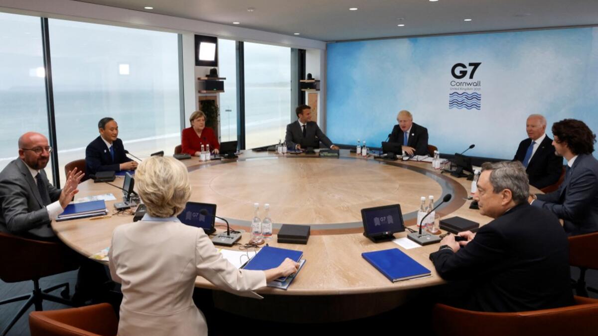 L-R) President of the European Council Charles Michel, President of the European Commission Ursula von der Leyen, Japan's Prime Minister Yoshihide Suga, Germany's Chancellor Angela Merkel, France's President Emmanuel Macron, Britain's Prime Minister Boris Johnson, US President Joe Biden, Canada's Prime Minister Justin Trudeau and Italy's Prime minister Mario Draghi attend a working sesssion at the G7 summit in Carbis Bay