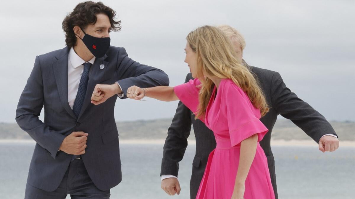 Britain's Prime Minister Boris Johnson (R) and his wife Carrie Johnson welcome Canada's Prime Minister Justin Trudeau prior to the start of the G7 summit in Carbis Bay, Cornwall on June 11, 2021. G7 leaders from Canada, France, Germany, Italy, Japan, the UK and the United States meet this weekend for the first time in nearly two years, for three-day talks in Carbis Bay, Cornwall.