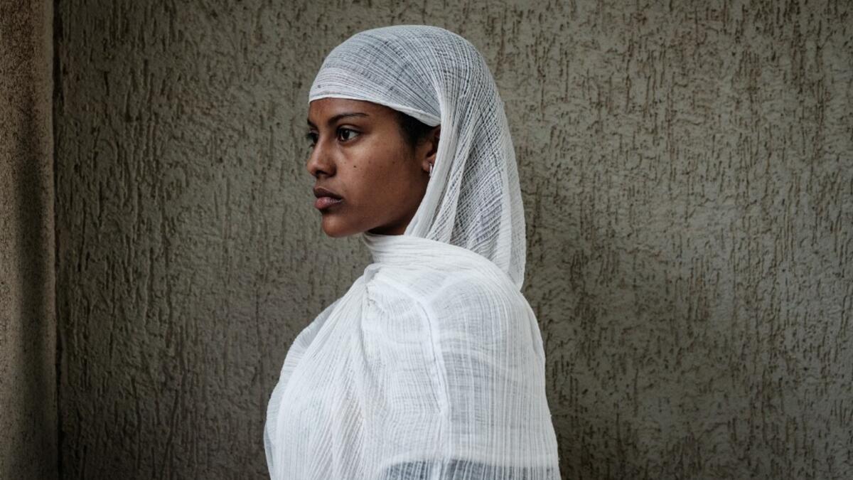 An Ethiopian Orthodox devotee waits to attend the Saint Michael's anniversary celebration at St. Michael church in Mekele, the capital of Tigray region, Ethiopia