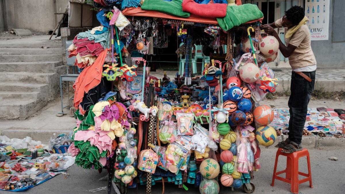 A man prepares to sell toys to Ethiopian Orthodox devotees before the start of the Saint Michael's anniversary celebration near St. Michael church in Mekele, the capital of Tigray region, Ethiopia