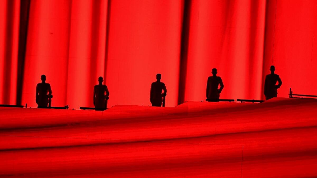 Performers are silhouetted as they take part in a Cultural Performance as part of the celebration of the 100th Anniversary of the Founding of the Communist Party of China, at the Bird's nest national stadium in Beijing
