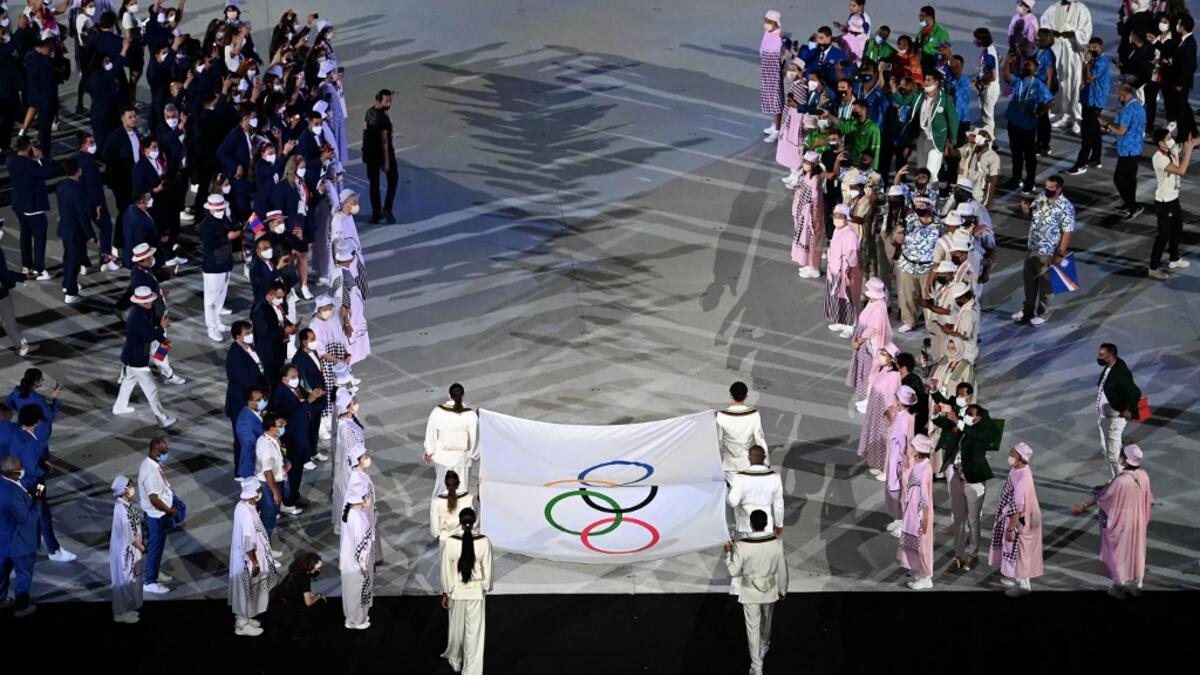 The Olympic flag is carried during the opening ceremony of the Tokyo 2020 Olympic Games, at the Olympic Stadium