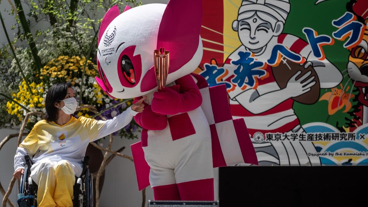 Tokyo 2020 torch relay ambassador Aki Taguchi interacts with the Tokyo 2020 Paralympic mascot Someity during a "flame gathering event" for the Tokyo 2020 Paralympic Torch Relay at the Metropolitan Government Building in Tokyo on August 20, 2021, ahead of the start of the Paralympic Games on August 24.