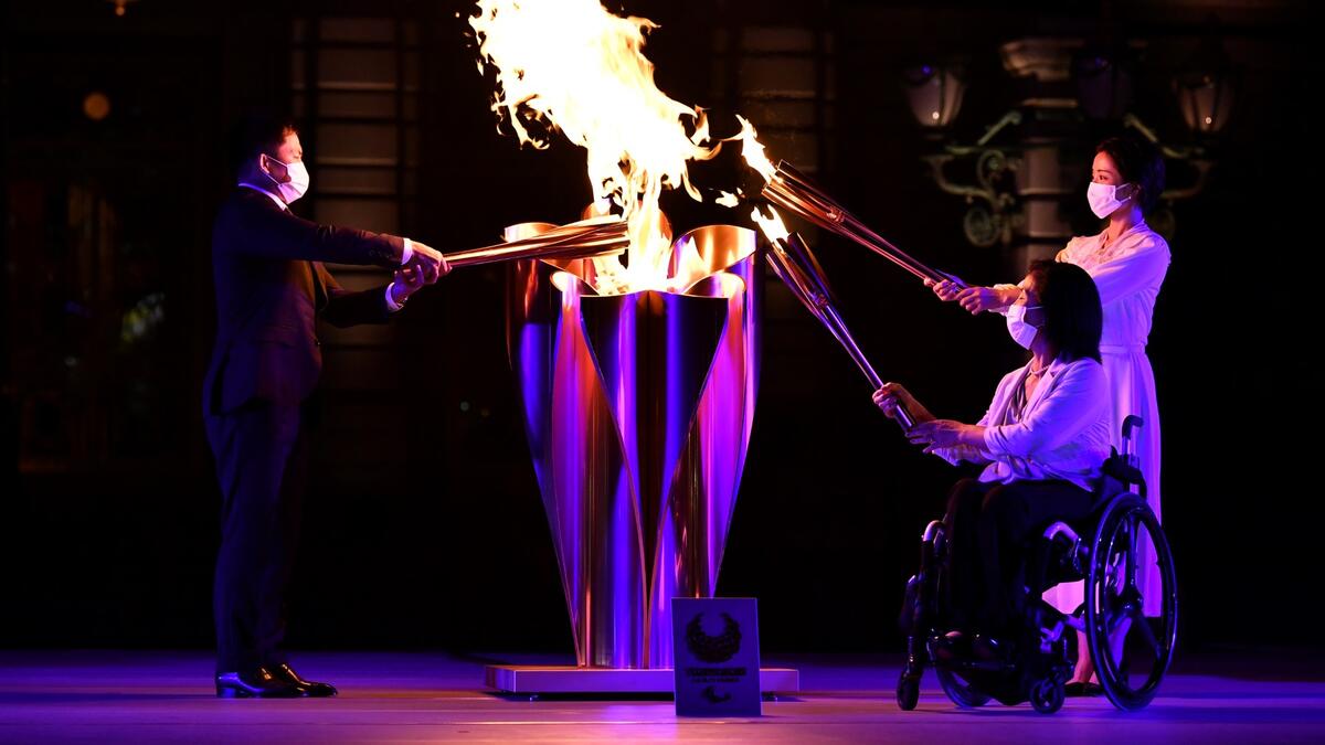 Tokyo 2020 Torch Relay Official Ambassadors Tadahiro Nomura (L), Aki Taguchi (2nd R), Satomi Ishihara (R) take part in the Paralympic Flame Lighting Ceremony at the State Guest House Akasaka Palace in Tokyo on August 20, 2021.