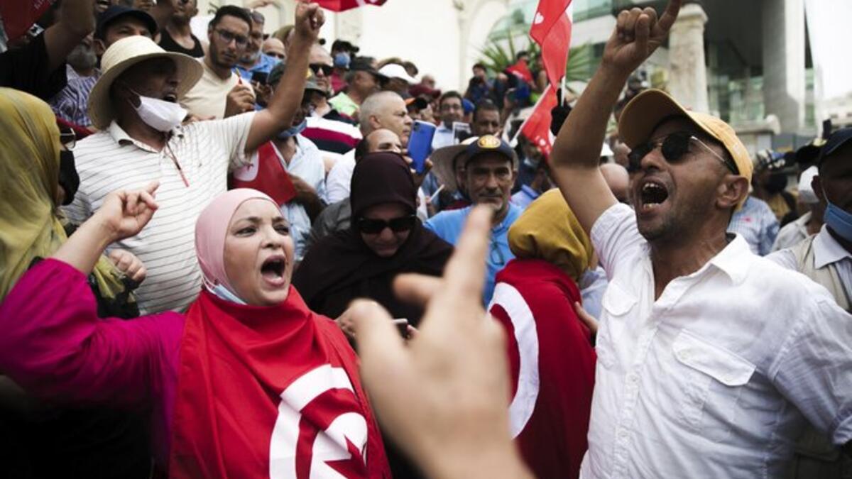 Protesters angry at the Tunisian president’s seizure of broad powers faced off with his supporters Saturday in competing demonstrations in the North African nation's capital of Tunis.