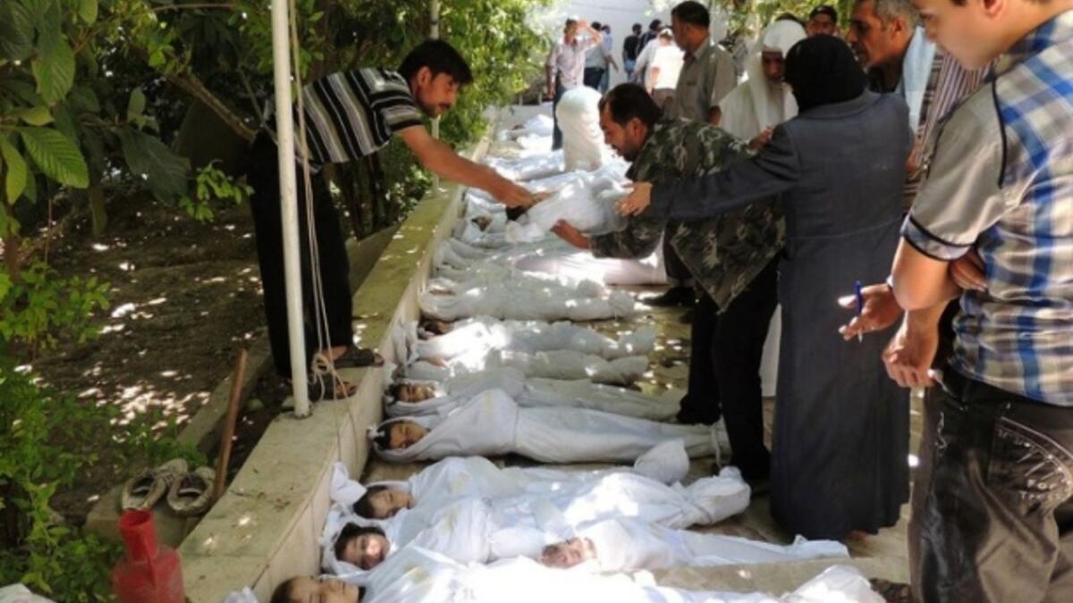 أطفال سوريا: تظهر مواطنين يحاولون التعرف على جثث القتلى من بينهم العديد من الأطفال أثناء نومهم، بعد هجوم بالغاز السام أطلقته قوات النظام. كان ذلك في 21 آب 2013.