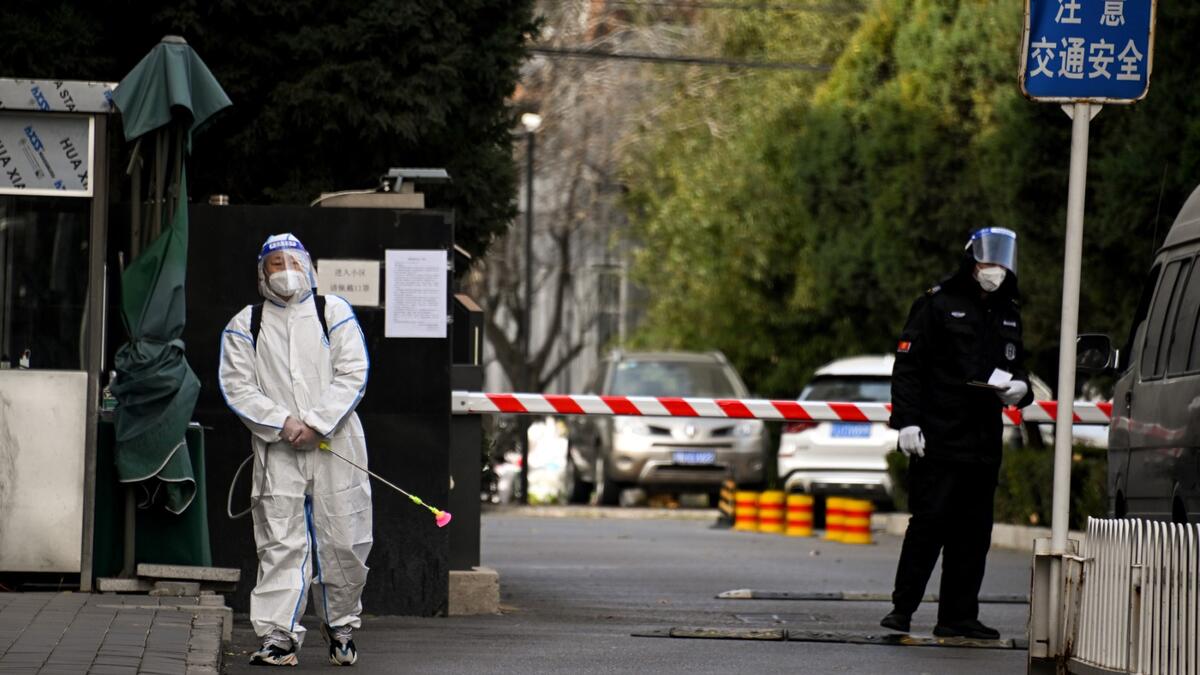 A worker in Chinese residential area under lockdown