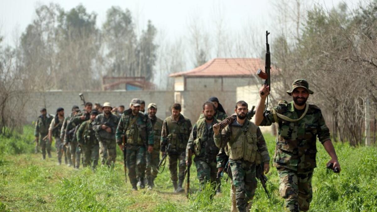 Syrian regime forces are pictured in the town of Aftris, west of the rebel-held town of Saqba, in the besieged Eastern Ghouta region on the outskirts of the capital Damascus, on Mar.10, 2018.  (AFP)