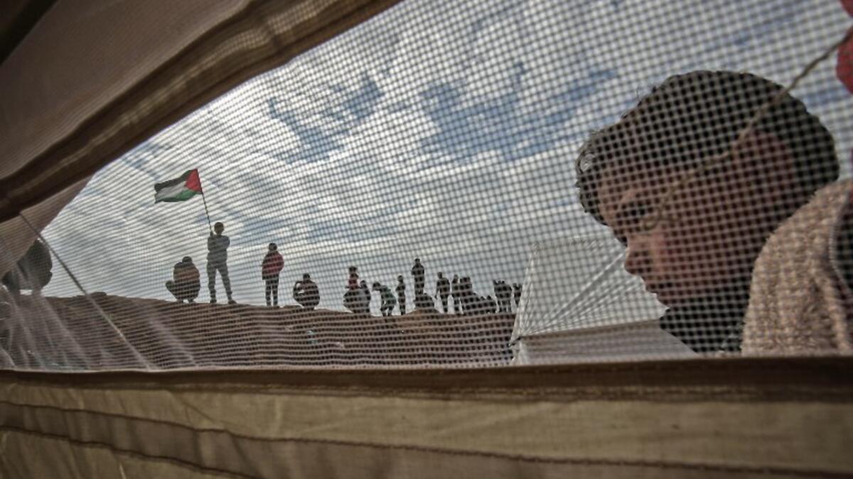 A Palestinian child stands outside a tent during a a tent city protest near Khan Yunis in the southern Gaza Strip on Mar. 30, 2018. Land Day marks the killing of six Arab Israelis during 1976 demonstrations against Israeli confiscations of Arab land.
(SAID KHATIB / AFP)