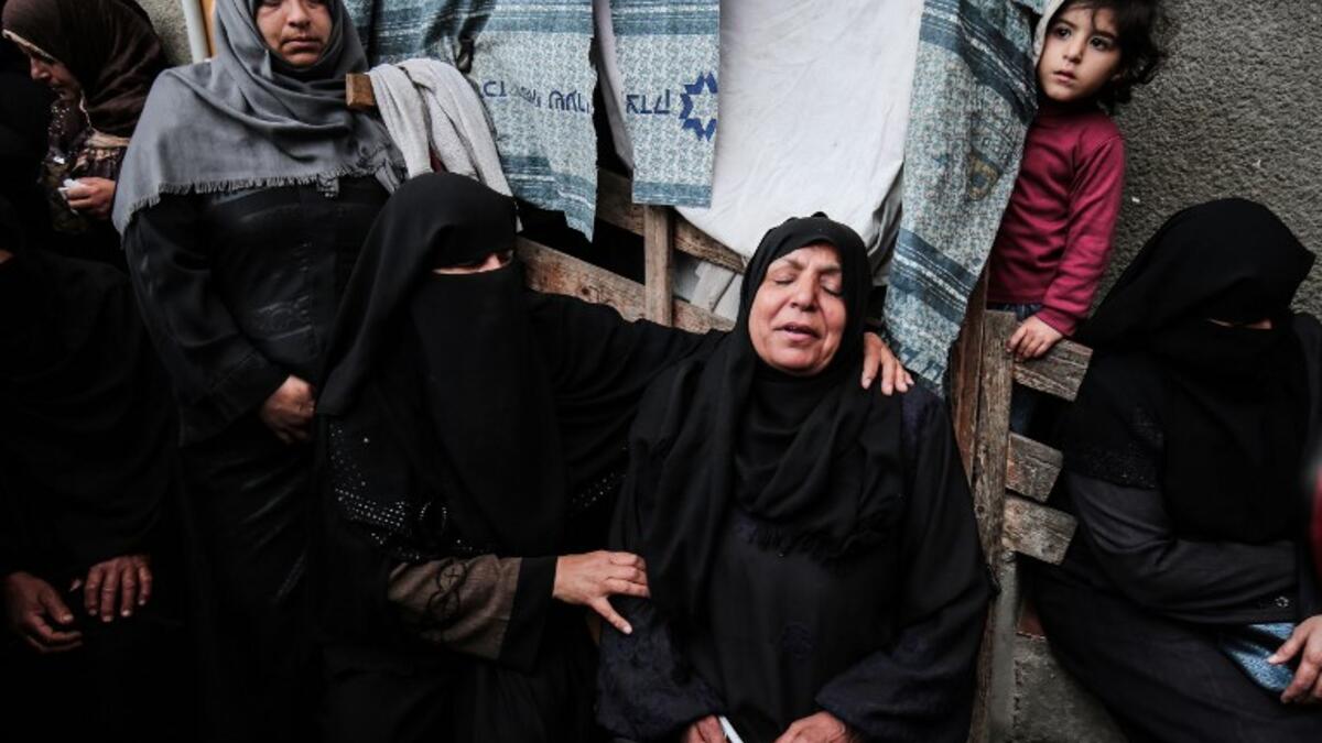 Relatives of Osama Qudeih, who was killed during clashes with Israeli forces on the Israeli-Gaza border, mourn during his funeral in Khan Yunis, in the southern Gaza Strip, on April 6, 2018. 
(SAID KHATIB / AFP)
