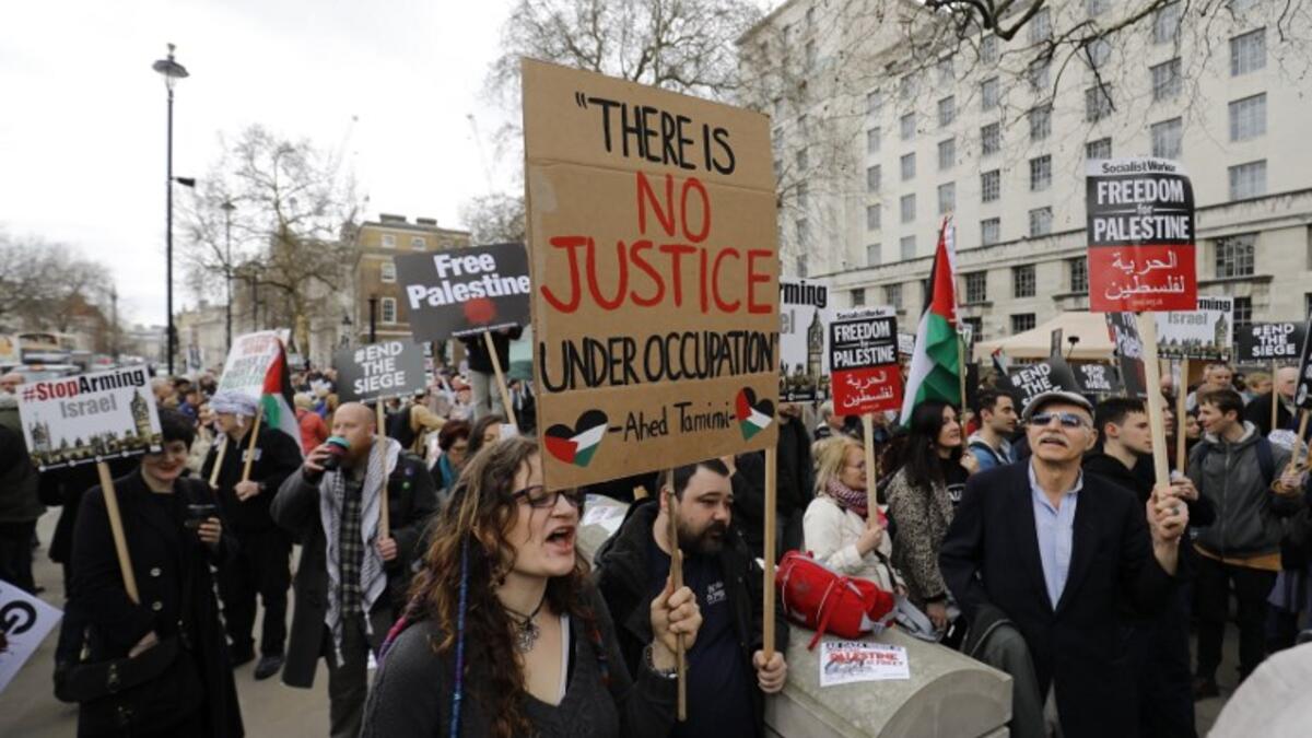 Protesters shout slogans and hold placards during a demonstration on Whitehall opposite Downing Street in central London on April 7, 2018 in support of the Palestianians in the Gaza Strip calling for a stop to the killing organised by the Palestinian Forum in Britain. 

(Tolga AKMEN / AFP)