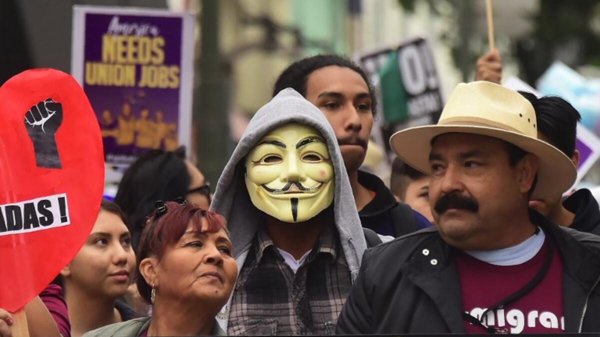 Demonstrators march through the city during May Day protests in Los Angeles, California on May 1, 2018 / AFP