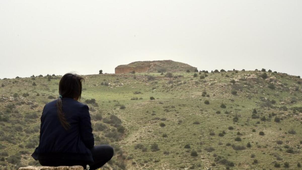A woman observes one of the Jeddars pyramid tombs, near the city of Tiaret, some 250 kilometres (155 miles) southwest of the Algerian capital, on April 23, 2018.
RYAD KRAMDI / AFP