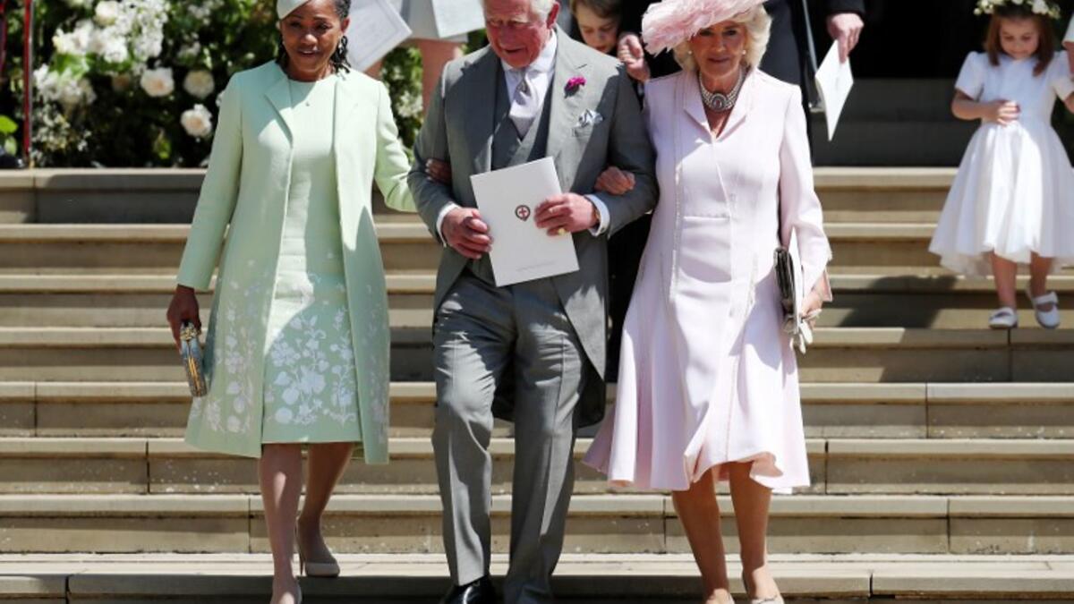 (L-R) Meghan Markle's mother Doria Ragland, Britain's Prince Charles, Prince of Wales (C) and Britain's Camilla, Duchess of Cornwall leave after the wedding ceremony of Britain's Prince Harry, Duke of Sussex and US actress Meghan Markle at St George's Chapel, Windsor Castle, in Windsor, on May 19, 2018. 
Jane Barlow/ AFP