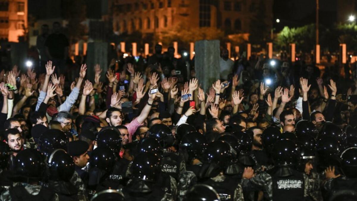 Jordanian protesters raise their hands in before members of the gendarmerie and security forces during a demonstration outside the Prime Minister's office in the capital Amman late on June 2, 2018.
Khalil MAZRAAWI / AFP