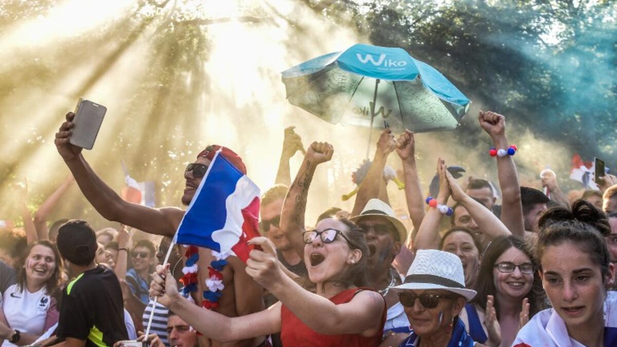 People celebrate France's victory in the Russia 2018 World Cup final football match between France and Croatia, on July 15, 2018 in Nantes city center. 
SEBASTIEN SALOM GOMIS / AFP