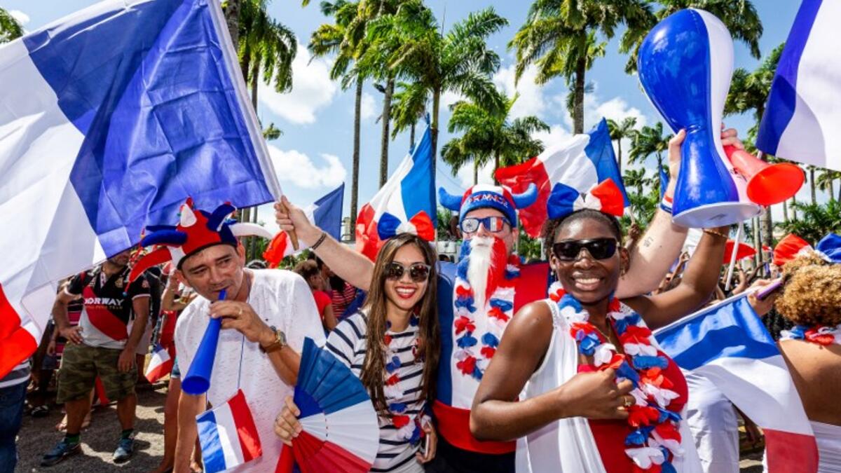 People celebrate in the streets of Cayenne, in French Guiana, on July 15, 2018, after France won the Russia 2018 World Cup final football match between France and Croatia. 
Jody AMIET / AFP