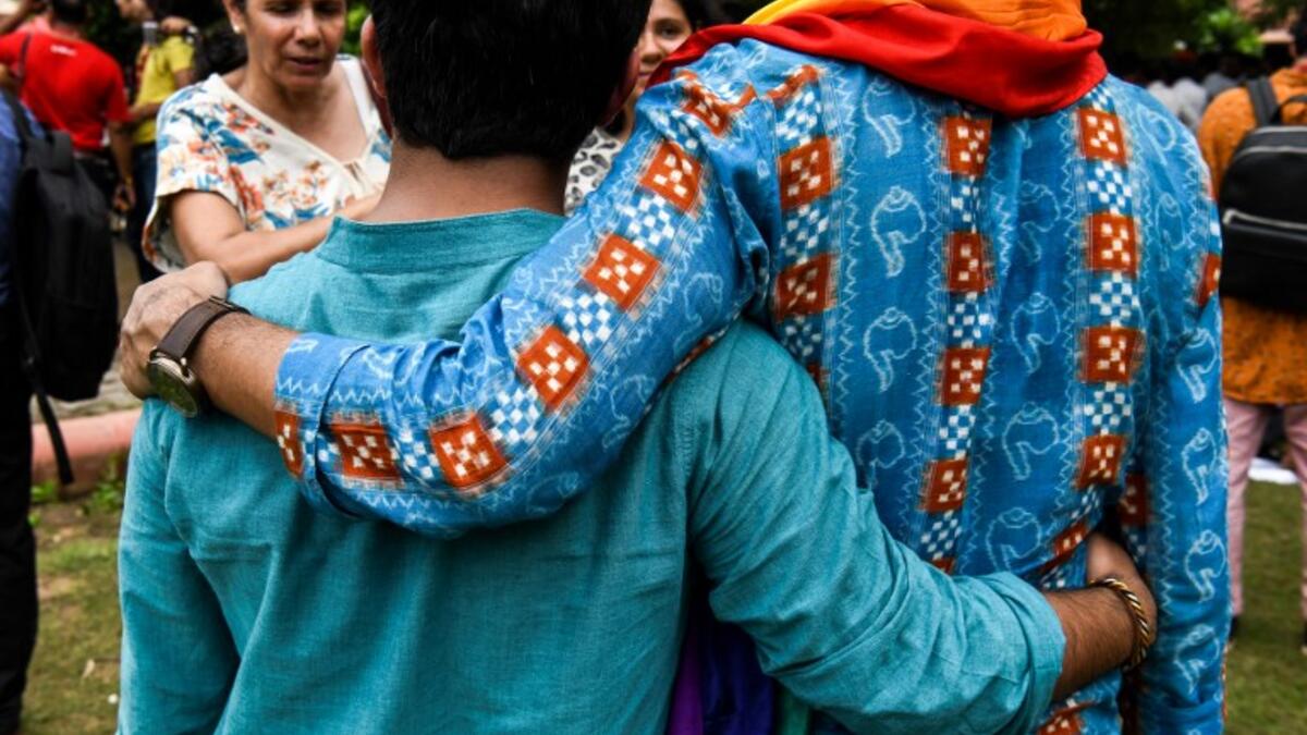 Indian members of the lesbian, gay, bisexual, transgender (LGBT) community pose for a picture outside the Supreme Court after the decision to strike down the colonial-era ban on gay sex in New Delhi on September 6, 2018. 
CHANDAN KHANNA / AFP