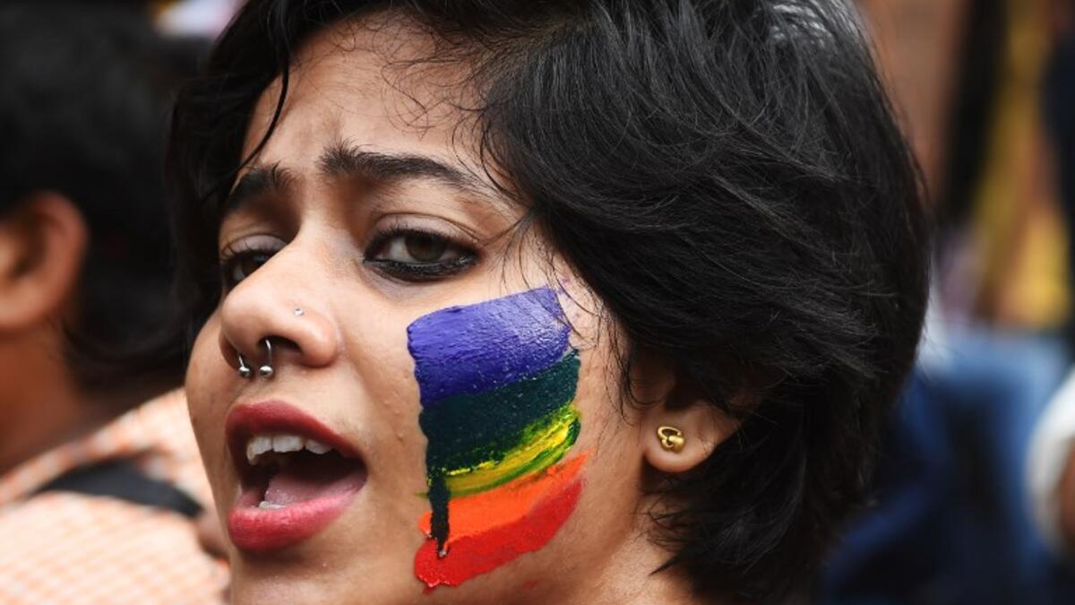 An Indian member and supporter of the lesbian, gay, bisexual, transgender (LGBT) community celebrates the Supreme Court decision to strike down a colonial-era ban on gay sex, in Kolkata on September 6, 2018. 
Dibyangshu SARKAR / AFP