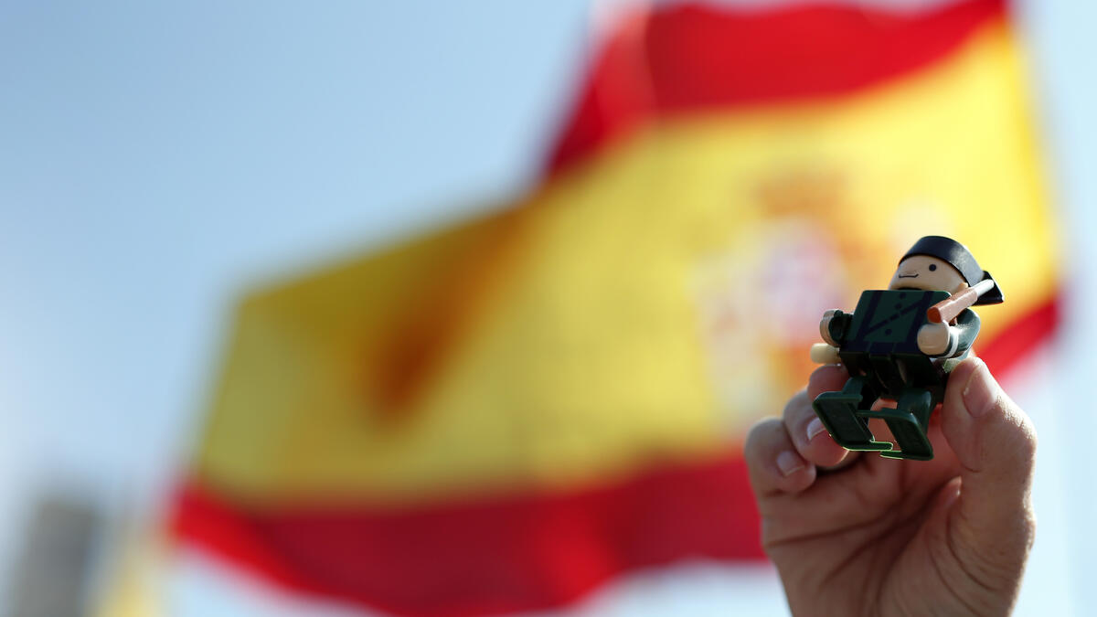 A person holds up a toy figurine depicting a civil guard during a demonstration in support of Spanish police in Barcelona on September 29, 2018. 
Pau Barrena / AFP