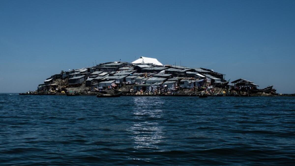 A picture taken on October 5, 2018, shows a newly-built tin roof shining on top of Migingo island which is densely populated by residents fishing mainly for Nile perch in Lake Victoria on the border of Uganda and Kenya. 
Yasuyoshi CHIBA / AFP