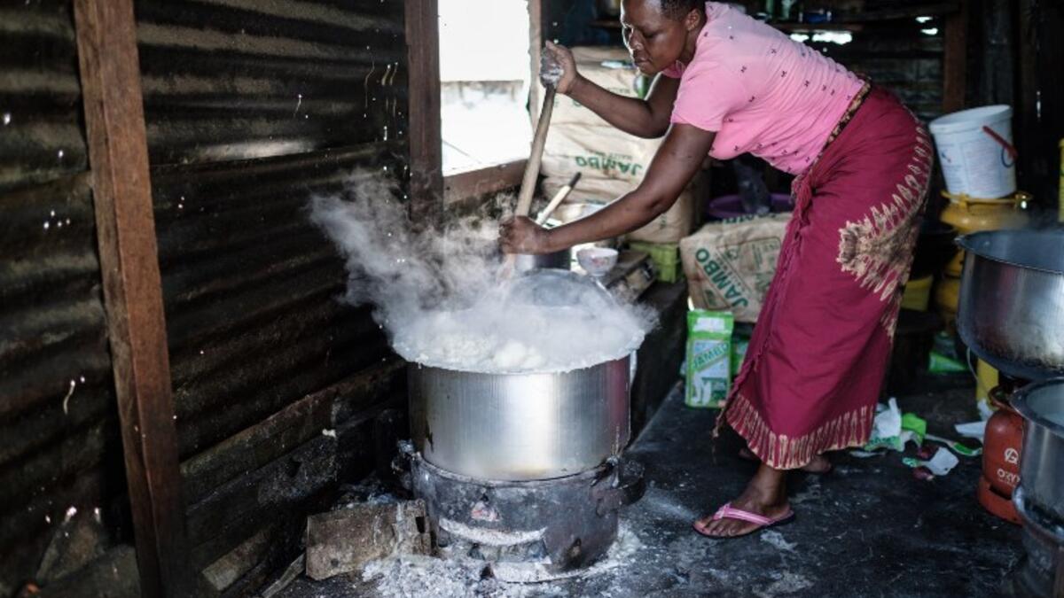 A woman prepares Ugali, a typical local food made of maize flour, on Migingo island on October 5, 2018 which is densely populated by residents fishing mainly for Nile perch in Lake Victoria on the border of Uganda and Kenya. 
Yasuyoshi CHIBA / AFP