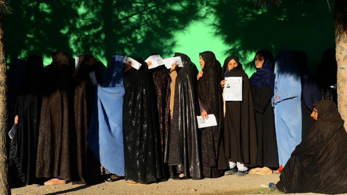 Afghan women wait in line to vote at a polling centre for the country's legislative election in Herat province on October 20, 2018.
HOSHANG HASHIMI / AFP