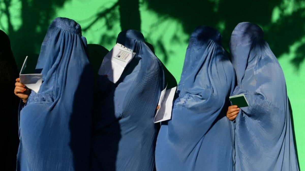 Afghan women wait in line to vote at a polling centre for the country's legislative election in Herat province on October 20, 2018.
HOSHANG HASHIMI / AFP