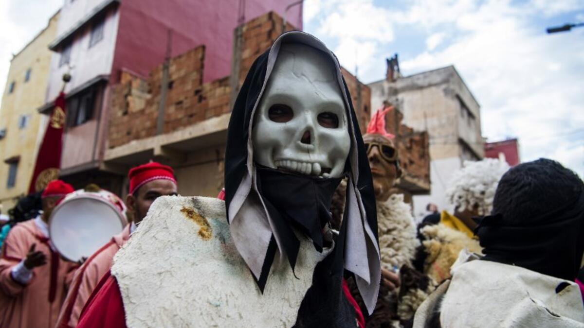 Young Moroccans take part in the Boujloud festival, a popular celebration also known as the 'Moroccan Halloween' in the Sidi Moussa district of Sale near Rabat, on October 27, 2018. 
FADEL SENNA / AFP