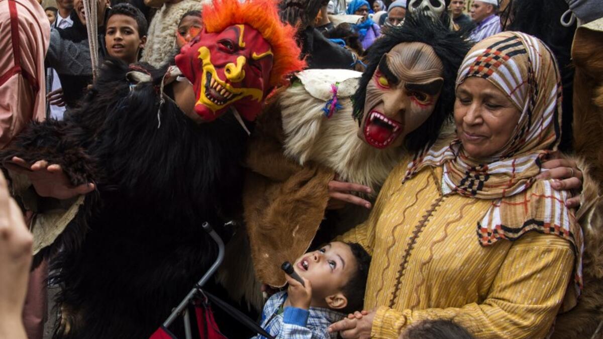 Young Moroccans take part in the Boujloud festival, a popular festival also known as the 'Moroccan Halloween' in the Sidi Moussa district of Sale near Rabat, on October 27, 2018. 
FADEL SENNA / AFP