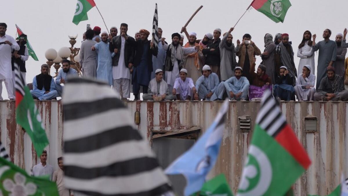 Pakistani supporters of the Ahle Sunnat Wal Jamaat (ASWJ) stand on a container set up to block a street during a protest rally following the Supreme Court's decision to acquit Christian woman Asia Bibi of blasphemy. (AAMIR QURESHI / AFP)